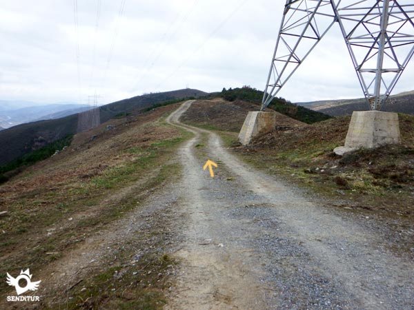 The undulating road seems to follow the course of the high-voltage line.